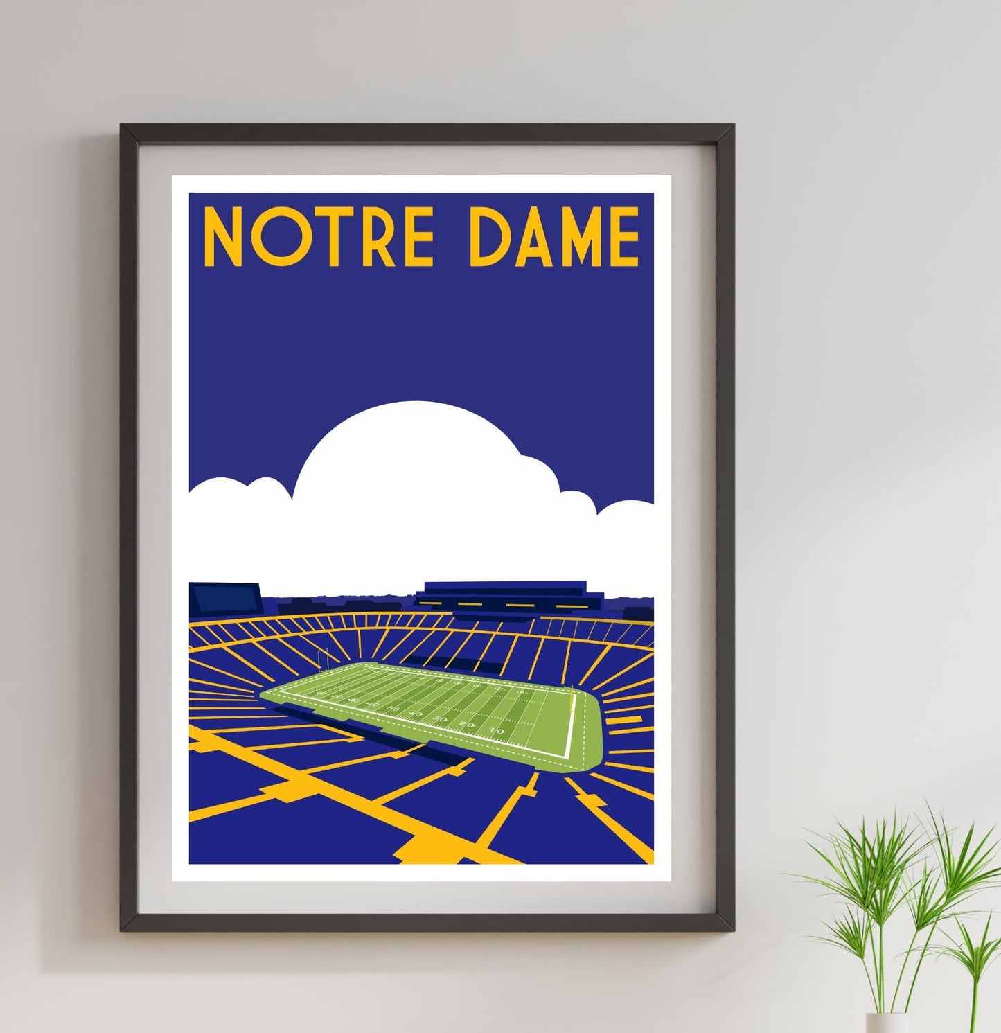 a framed poster of a stadium with a green field
