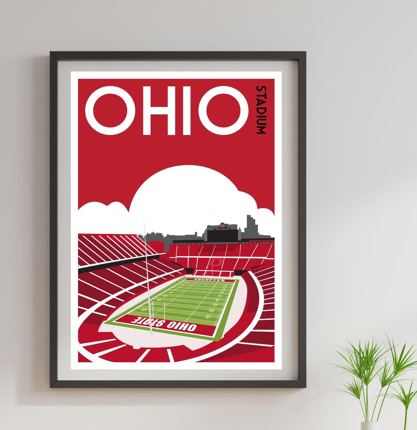 a framed poster of a stadium with a football field
