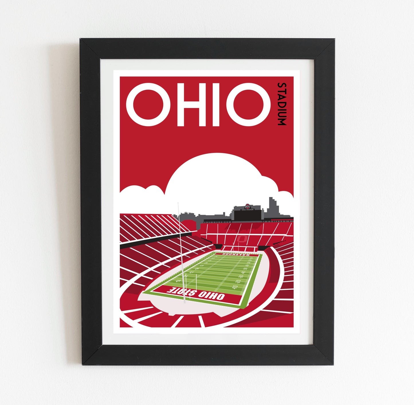 a framed poster of a stadium with a football field