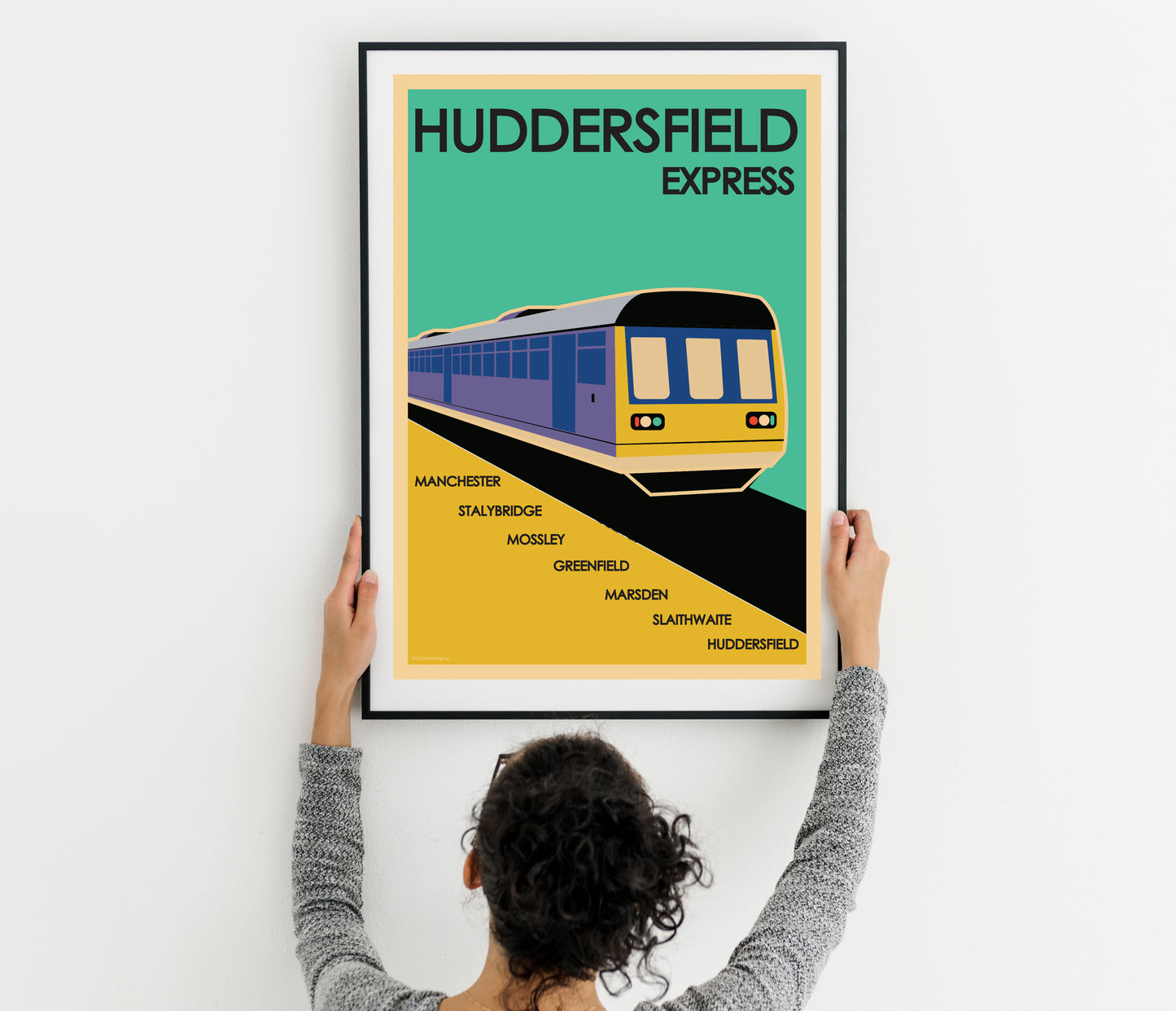 Manchester Express: Vintage Retro Travel Art Print Poster with a woman holding up a poster with a train on it