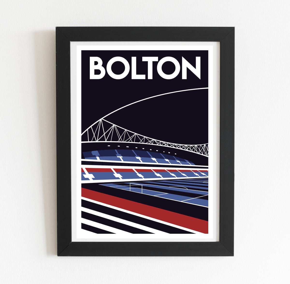 A framed poster depicting a stadium with a bridge in the background.