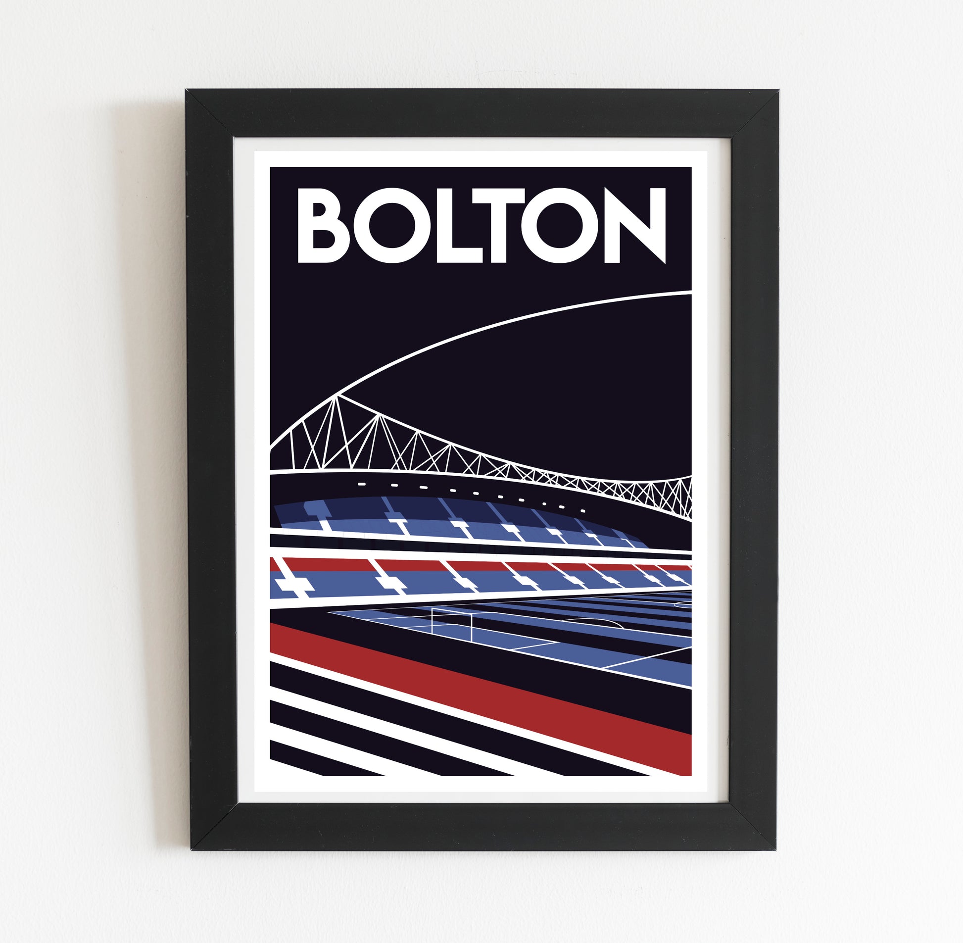 A framed poster depicting a stadium with a bridge in the background.