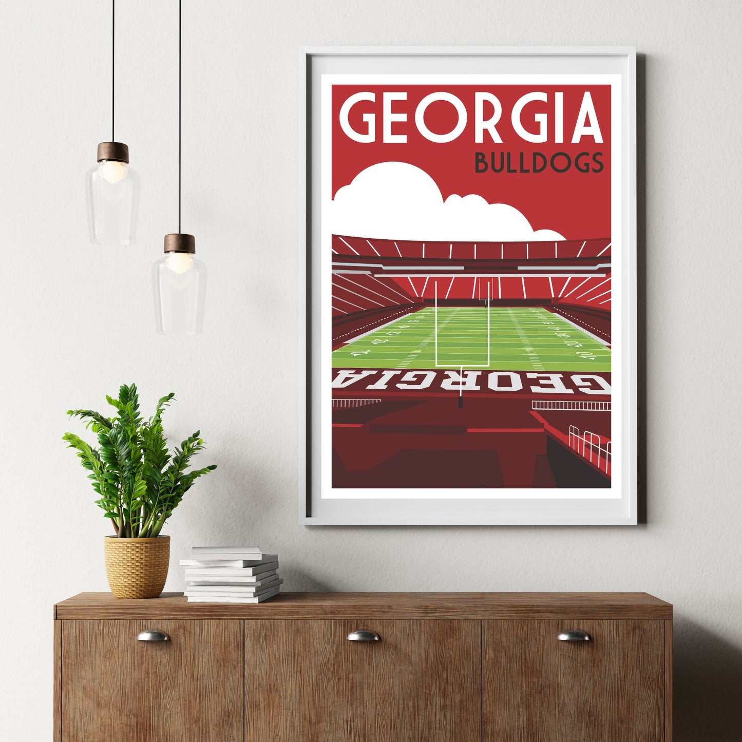 a framed poster of a football stadium with the text "GEORGIA BULLDOGS" displayed prominently.