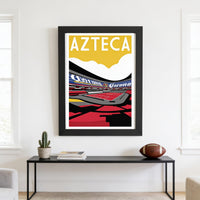 a framed poster of a sports stadium, specifically Azteca, hanging on a wall above a black console table with a football and some books on it.