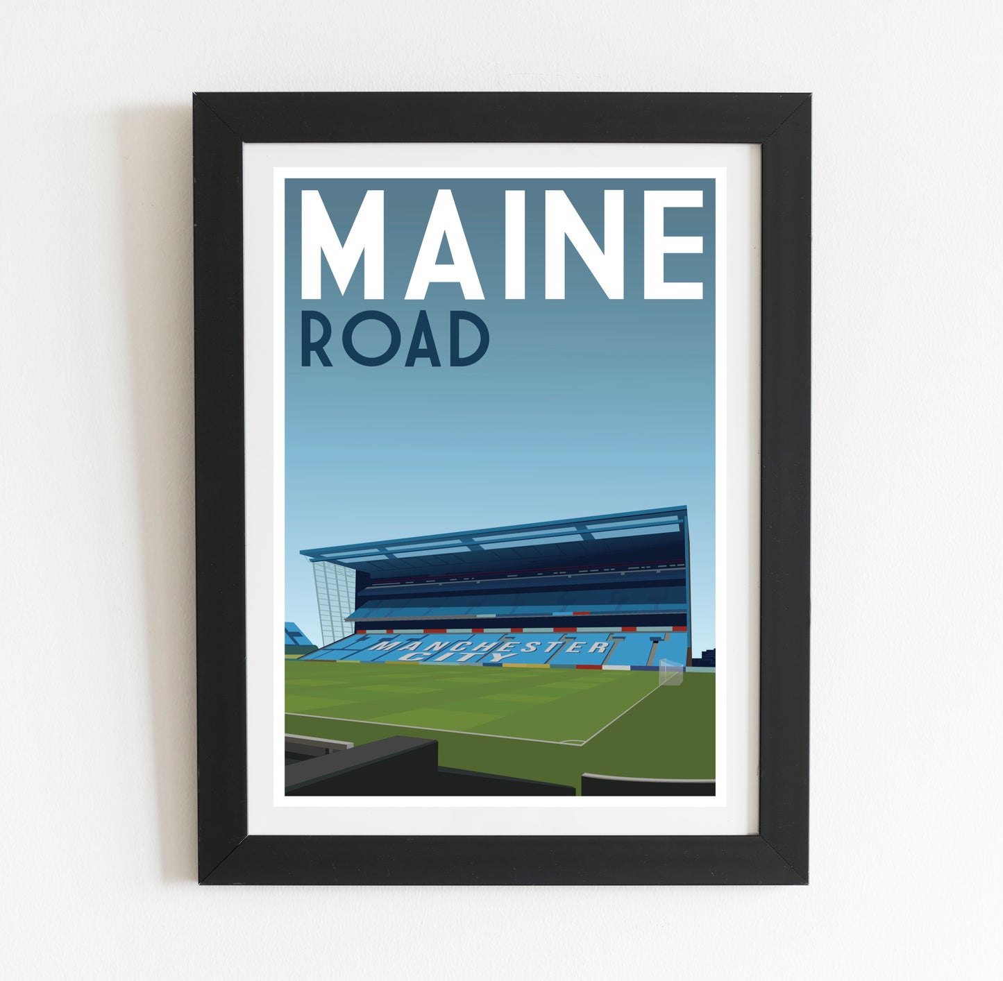 a framed poster of a stadium with the name maine road