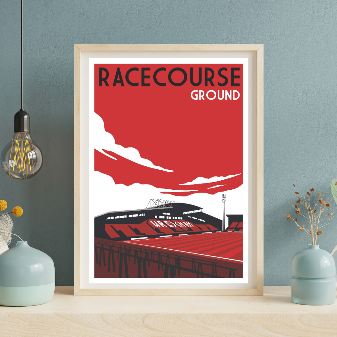 a framed poster of a stadium with a red and white color scheme, depicting a sports stadium with a large scoreboard and seating area.
