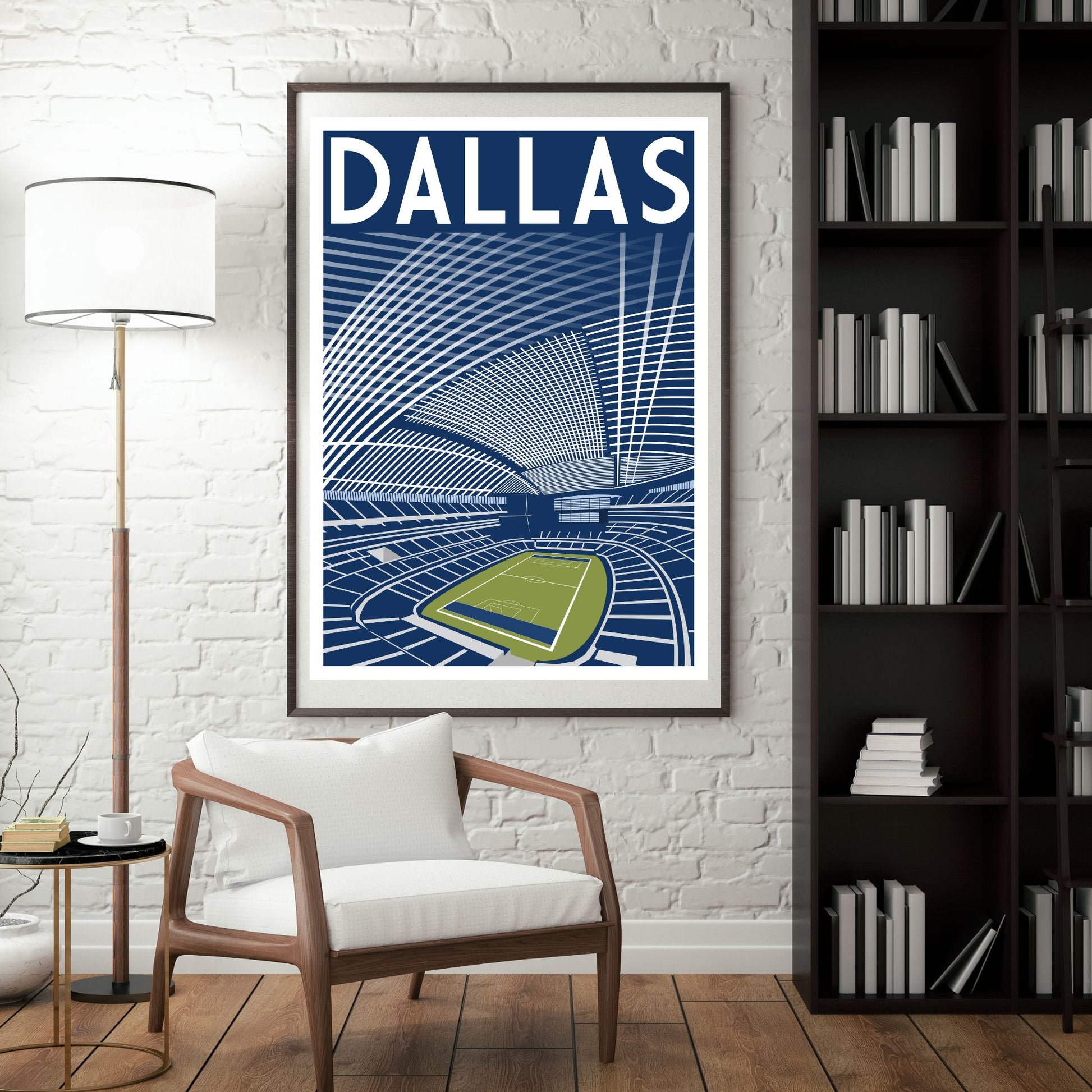 a framed poster of a stadium with a tennis court, hanging on a wall in a room with a white chair and a bookshelf.