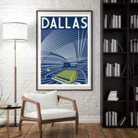 a framed poster of a stadium with a tennis court, hanging on a wall in a room with a white chair and a bookshelf.