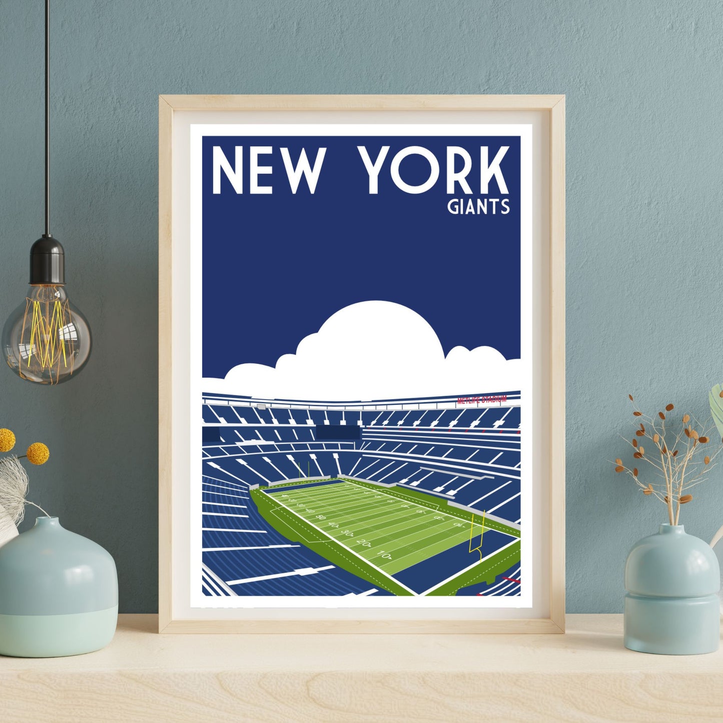 a framed poster of a football stadium with the text "NEW YORK GIANTS" displayed prominently.