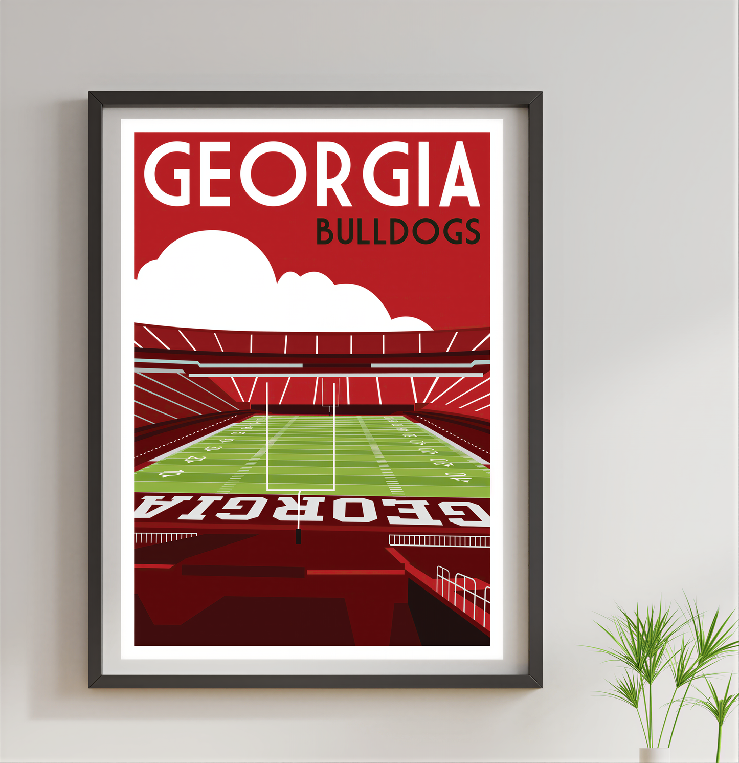 A framed poster depicting a football stadium with the text "GEORGIA BULLDOGS" prominently displayed.