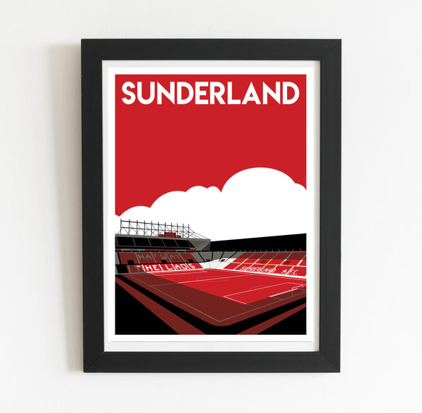 A framed poster depicting a stadium with a red field and white seating, with the text "SUNDERLAND" prominently displayed.
