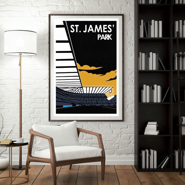 a framed poster of St. James' Park, a stadium located in St. James, England. The poster is displayed on a white brick wall, and there is a white chair in the foreground.