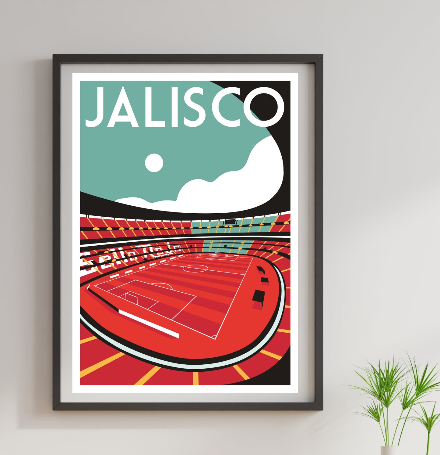 A framed poster depicting a soccer stadium with a red field and white goalposts, set against a blue sky with a white cloud.