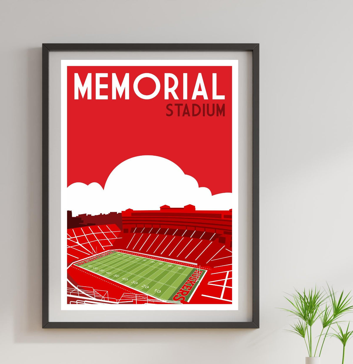 a framed poster of a stadium with a green field
