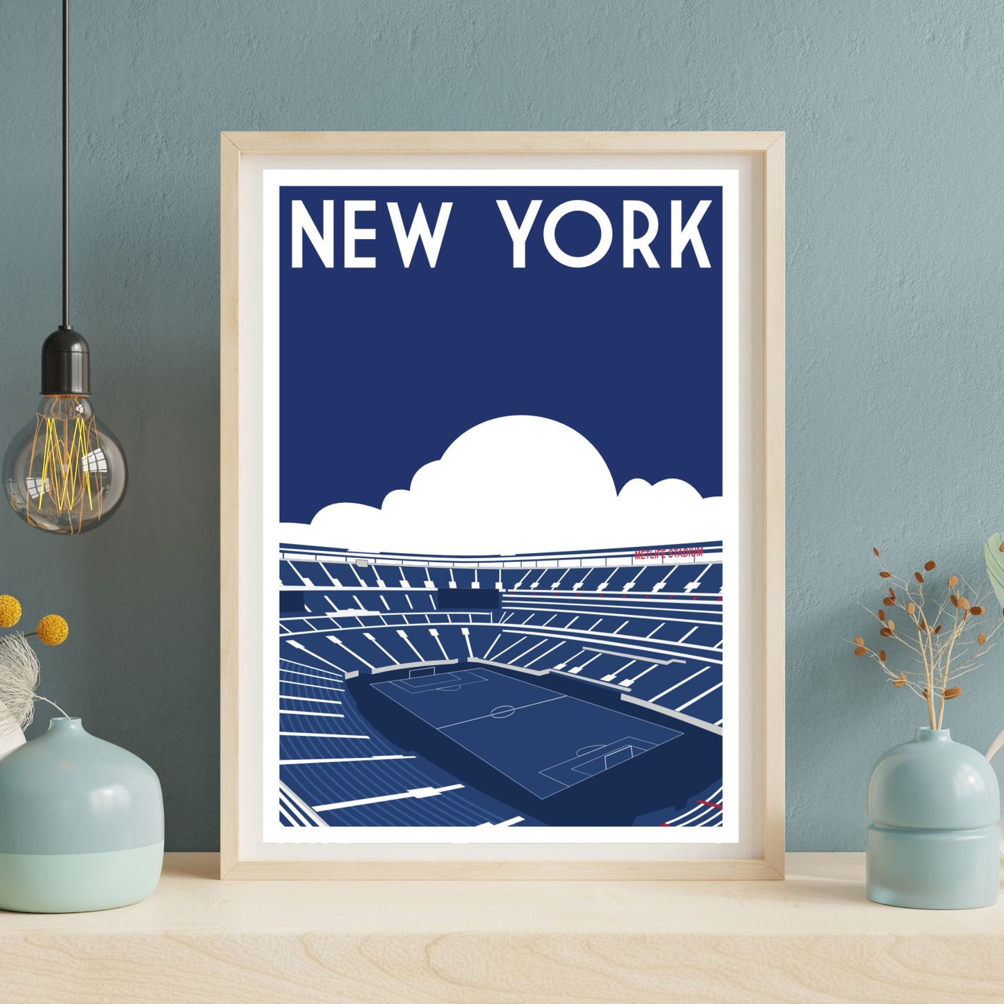 A framed poster depicting a stadium with a cloudy sky in the background, accompanied by the text "NEW YORK" in the center.