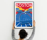A person is holding up a framed poster of a soccer stadium in Boston.