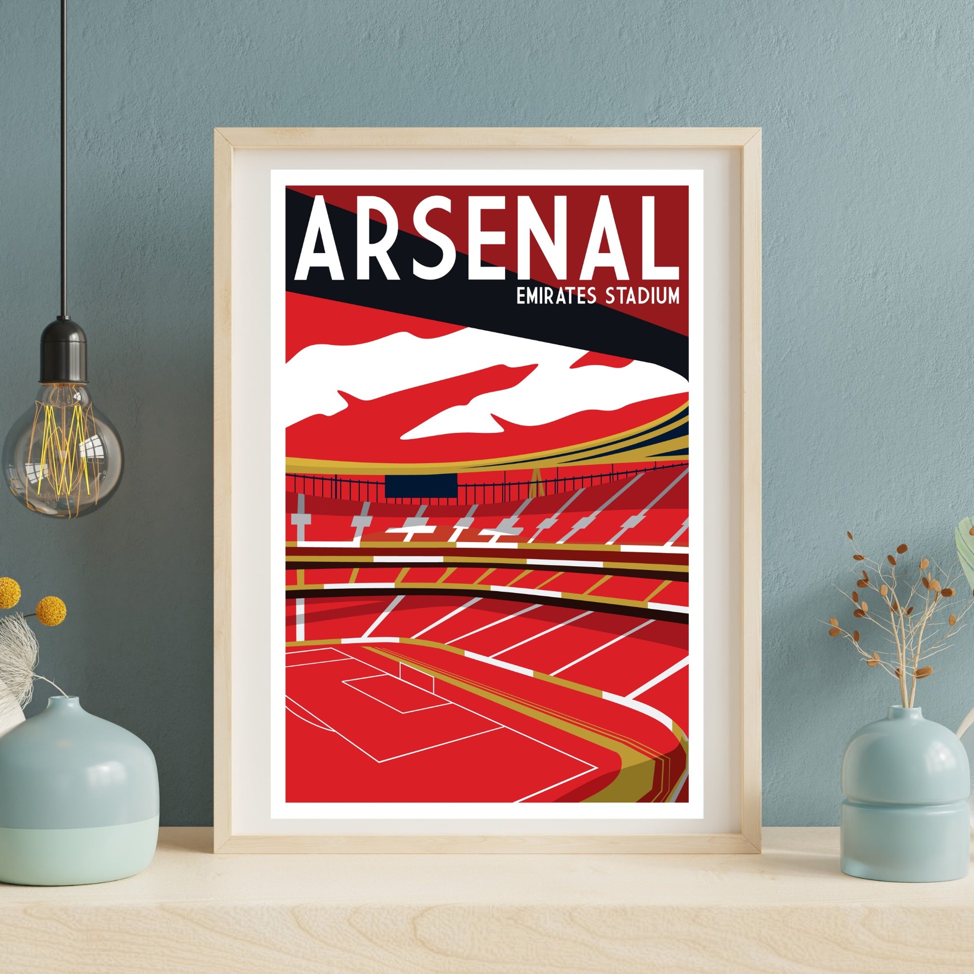 a framed poster of Arsenal football stadium, with a red and white color scheme and a depiction of the stadium's interior.