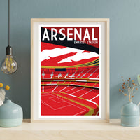 a framed poster of Arsenal football stadium, with a red and white color scheme and a depiction of the stadium's interior.