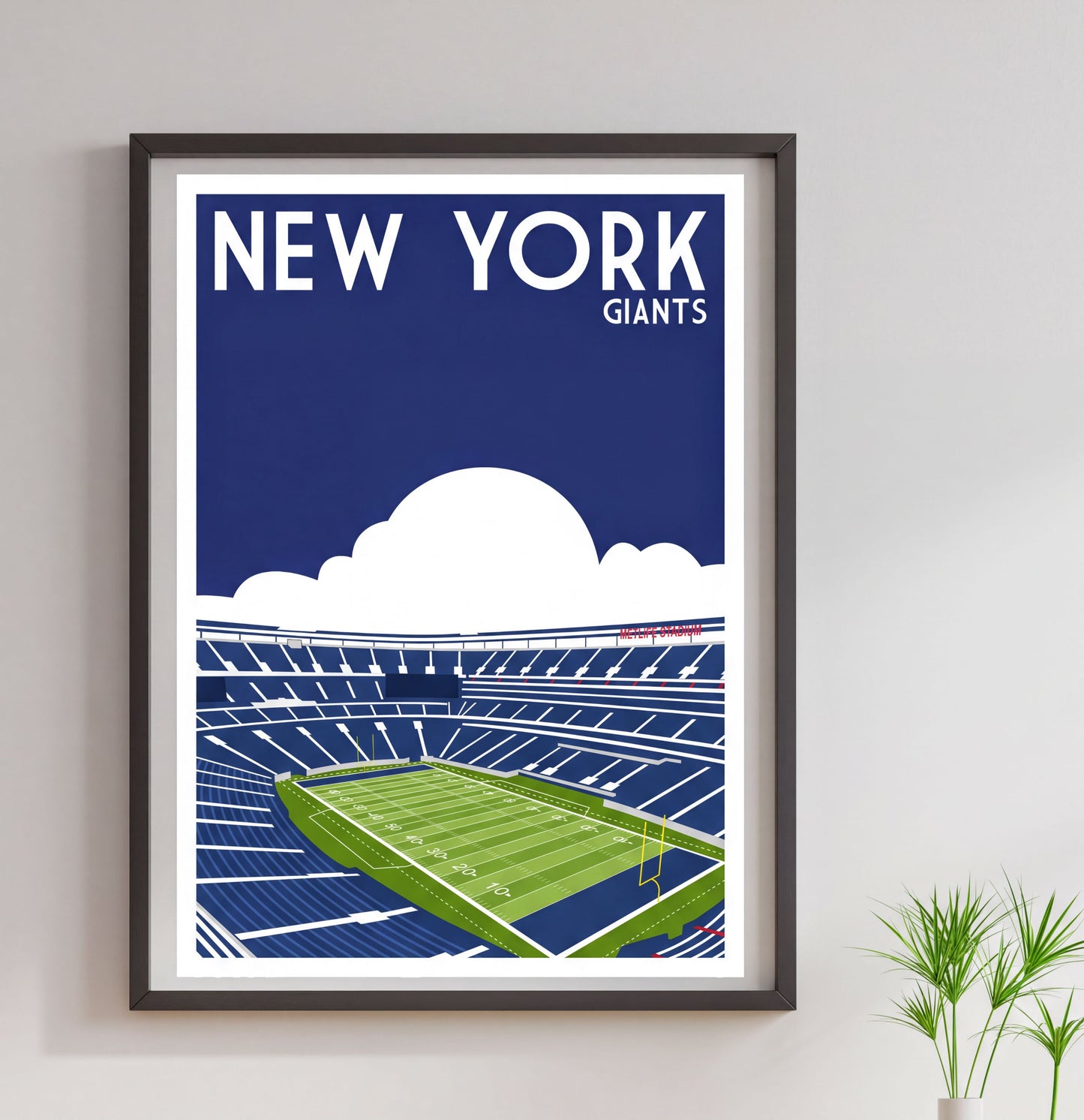 A framed poster depicting a football stadium with the text "NEW YORK GIANTS" above it.