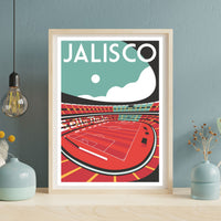 A framed poster depicting a soccer stadium with a red field and white lines, set against a blue sky with a white moon.