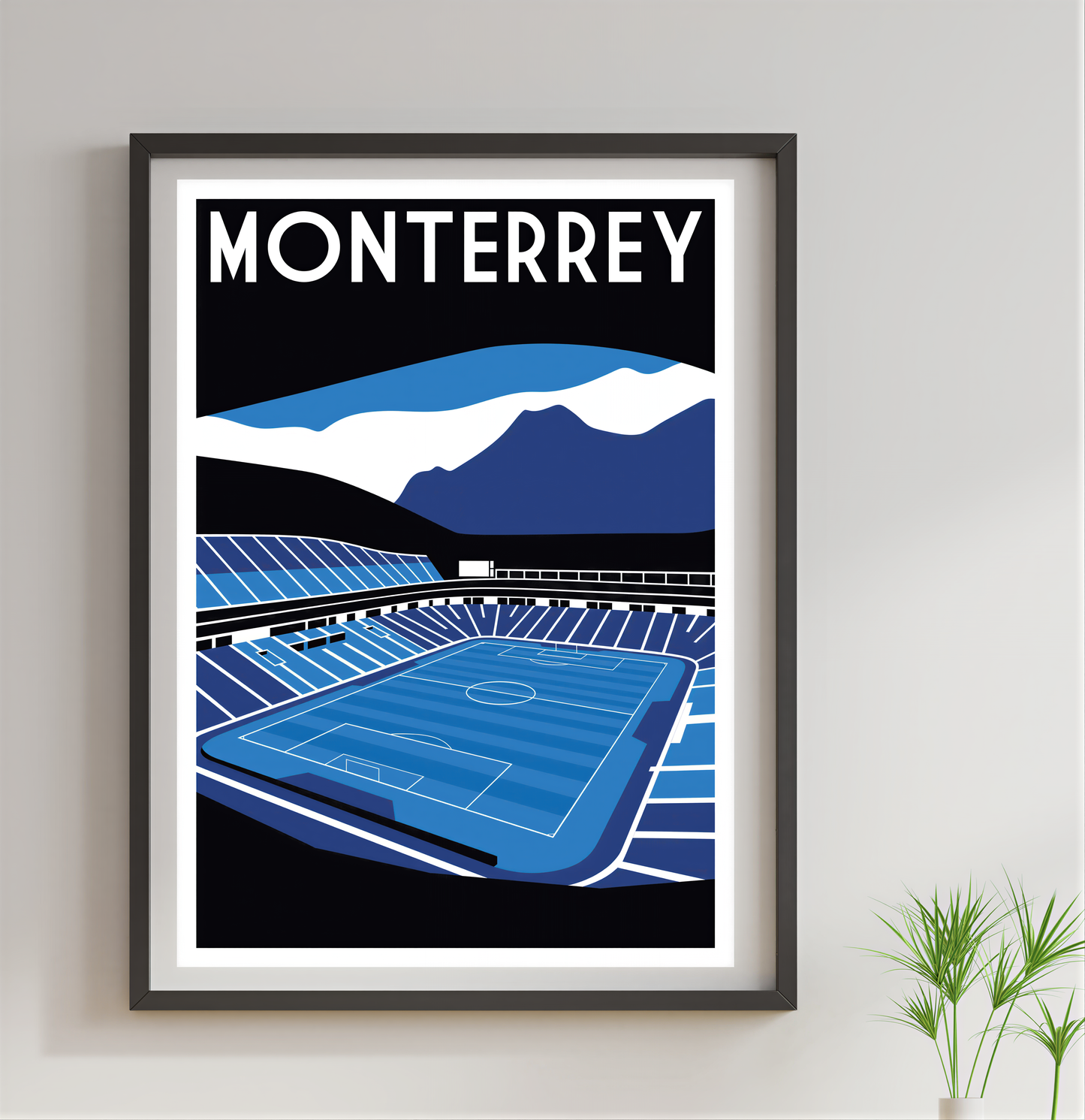 The image is a framed poster depicting a soccer stadium with mountains in the background.