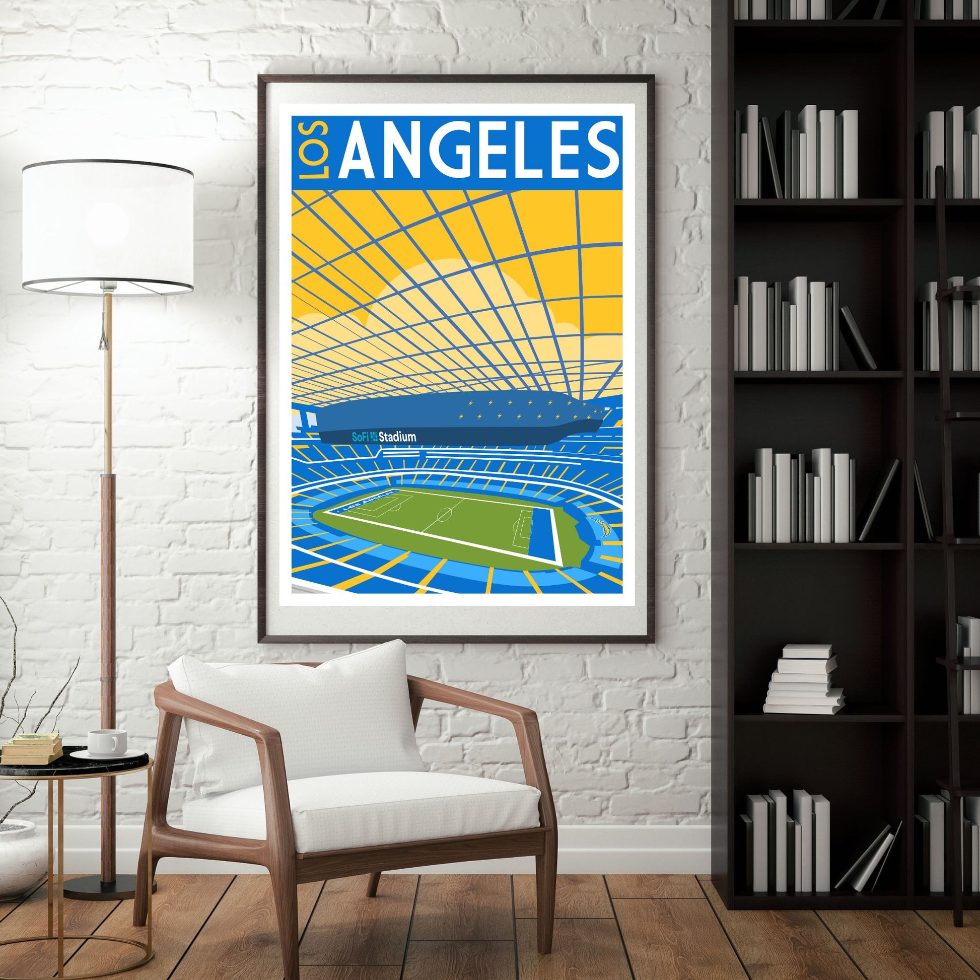 a framed poster of a stadium with a tennis court, hanging on a wall in a room with a white chair and a bookshelf.
