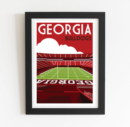 A framed poster depicting a football stadium with the text "GEORGIA BULLDOGS" prominently displayed.