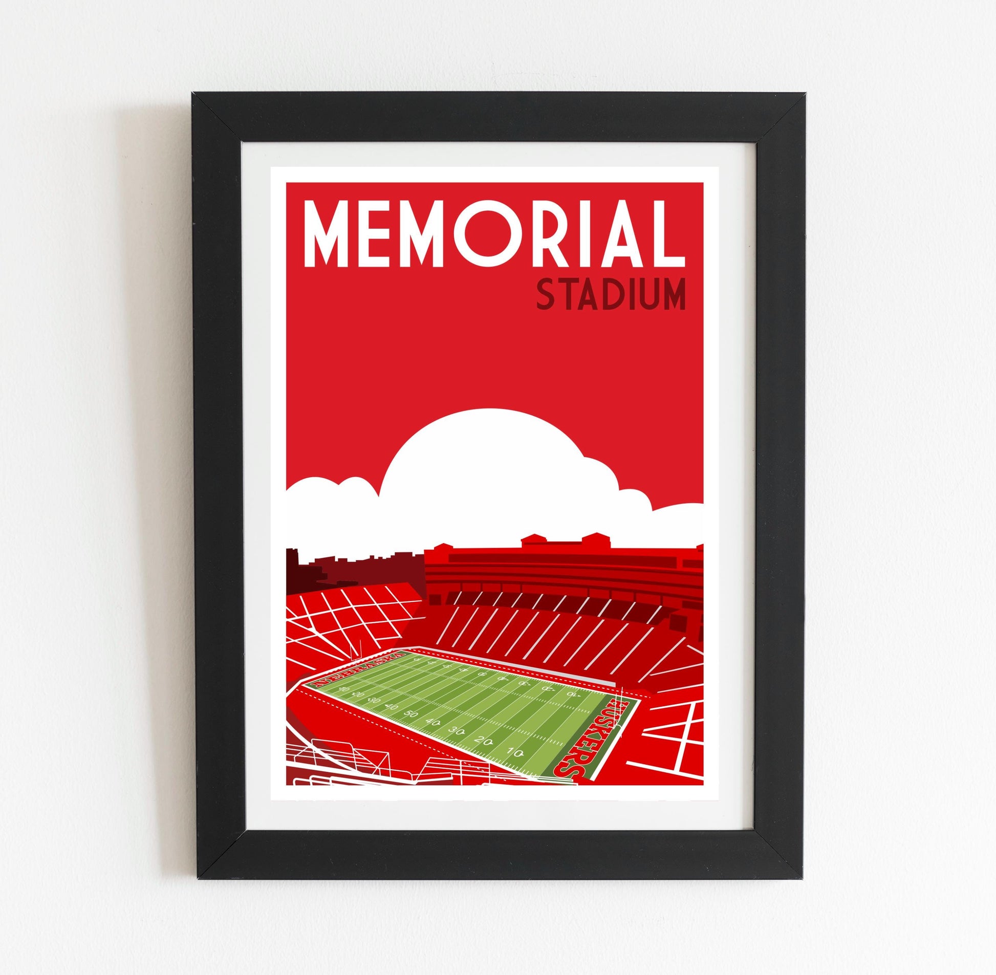 a framed poster of a stadium with a red sky