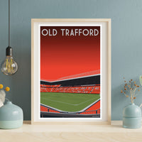 a framed poster of a football stadium with a red and green color scheme, displaying the text "OLD TRAFFORD" prominently.