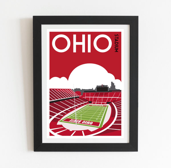 a framed poster of a stadium with a football field